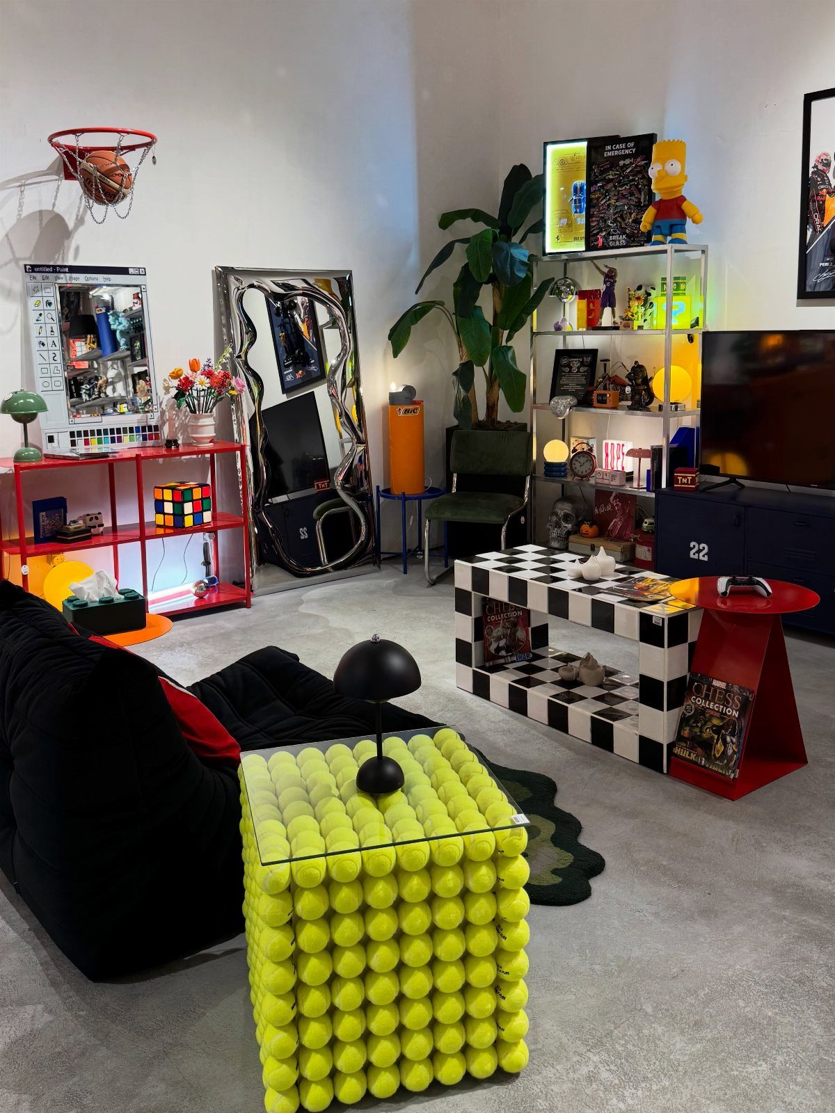 Eclectic living room with a tennis ball cube table and checkered coffee table.