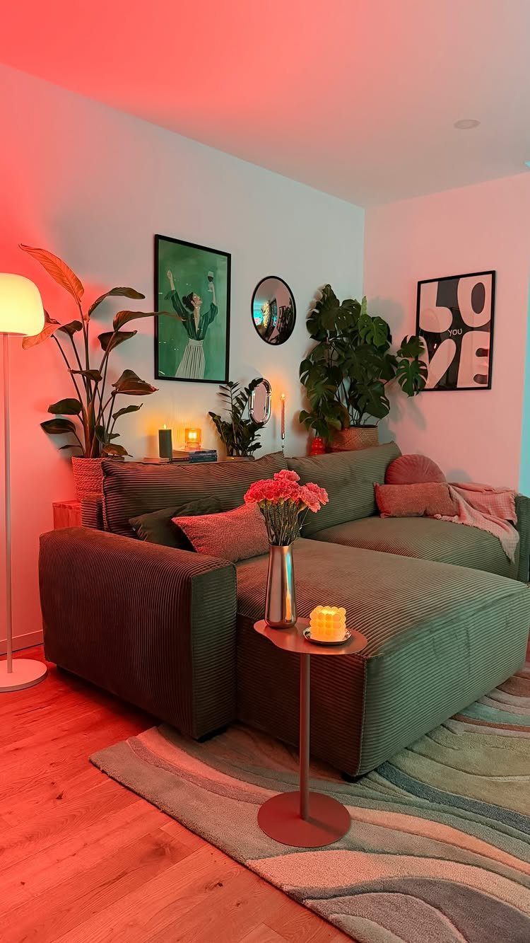 Green sectional sofa with a chaise lounge on a wavy patterned rug.
