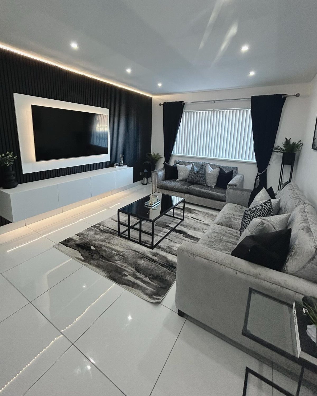 Grey textured area rug in a modern black and white living room