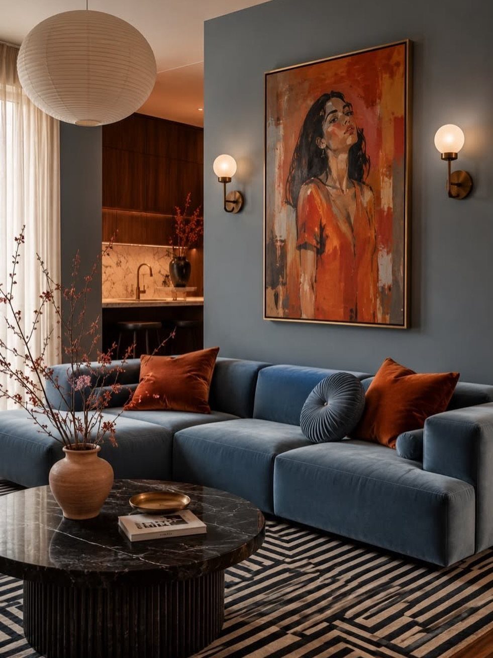Blue modular sofa with orange pillows and a black marble coffee table.