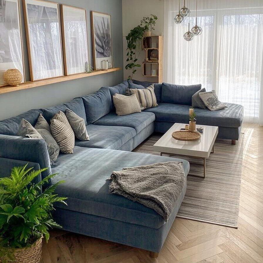 Powder-blue sectional sofa with throw pillows in a bright, modern living room setting.