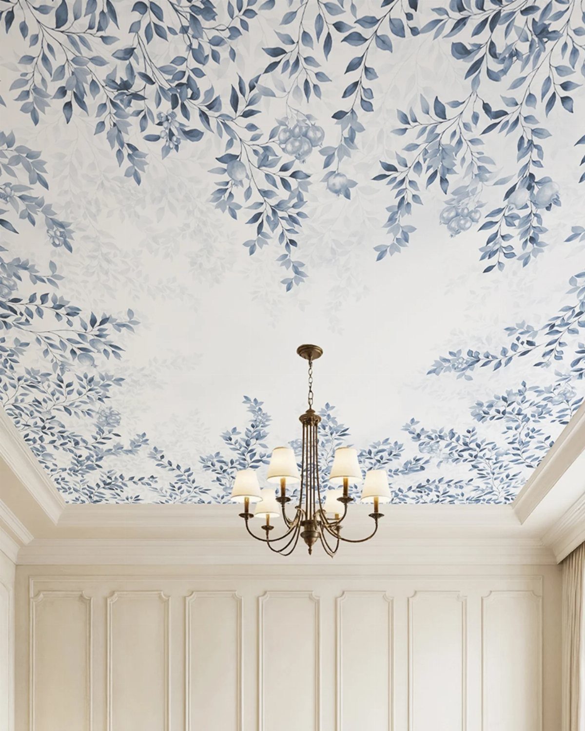 Blue botanical leaf wallpaper on a white ceiling with a gold chandelier