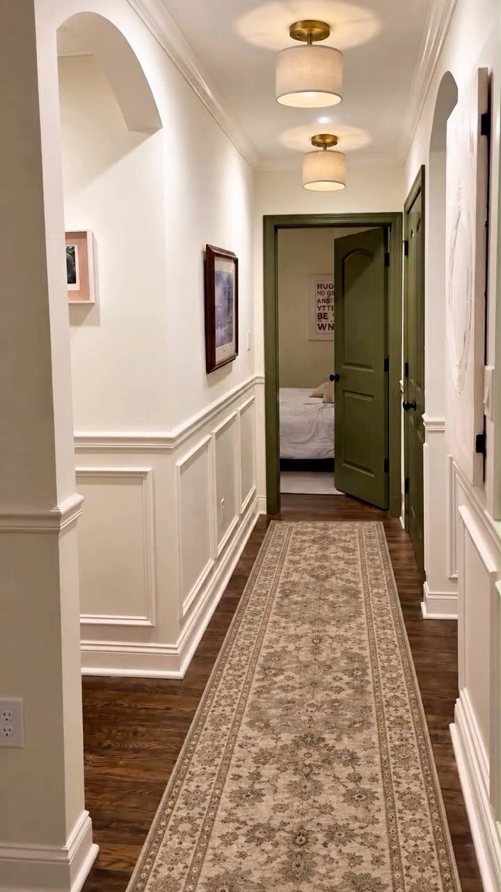 White board and batten wainscoting with chair rail in a hallway with runner rug.