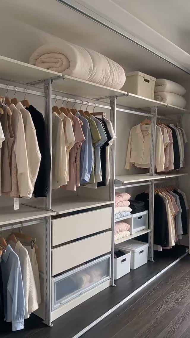 White modular closet system with adjustable shelving, hanging rods, and storage drawers.