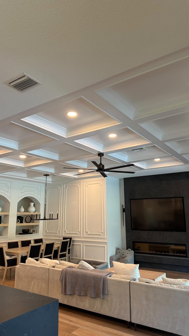 White square grid coffered ceiling in an open concept living and dining room