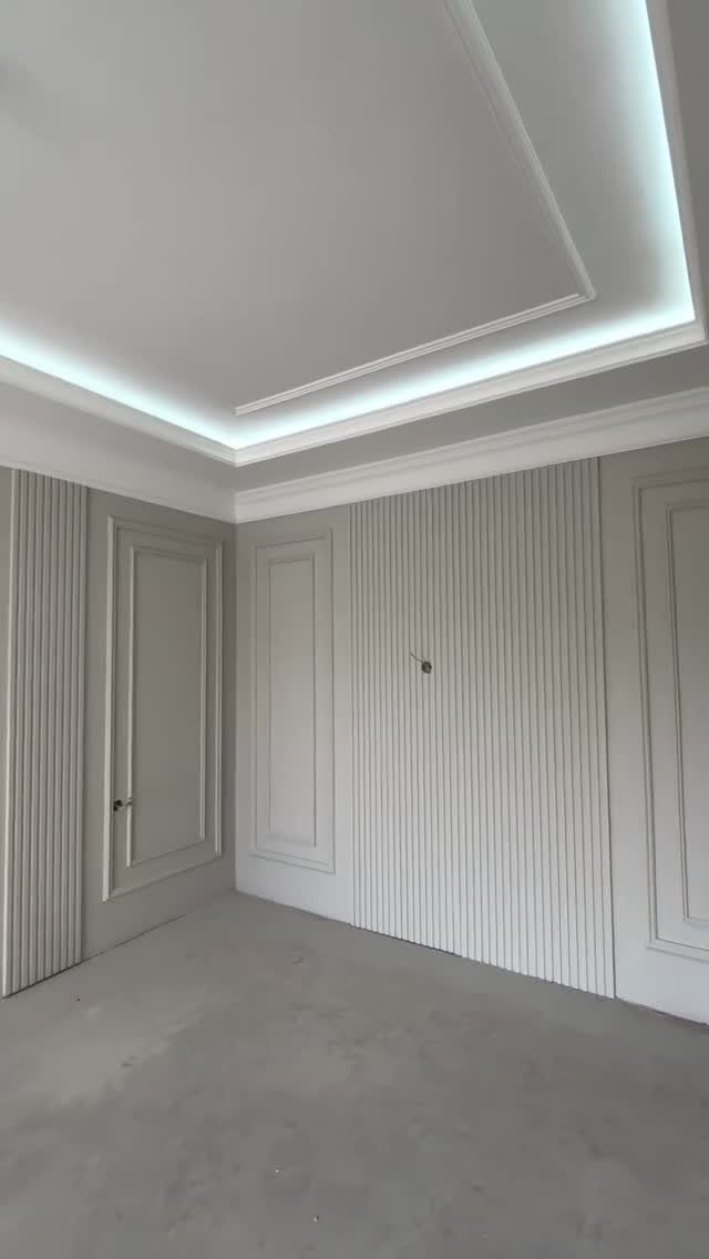 Modern white tray ceiling with flat panels and integrated LED perimeter lighting.
