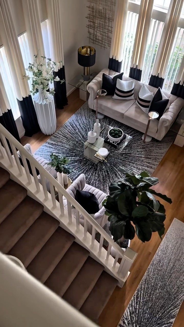 Living room with a monochromatic white, black, and grey color palette and greenery.