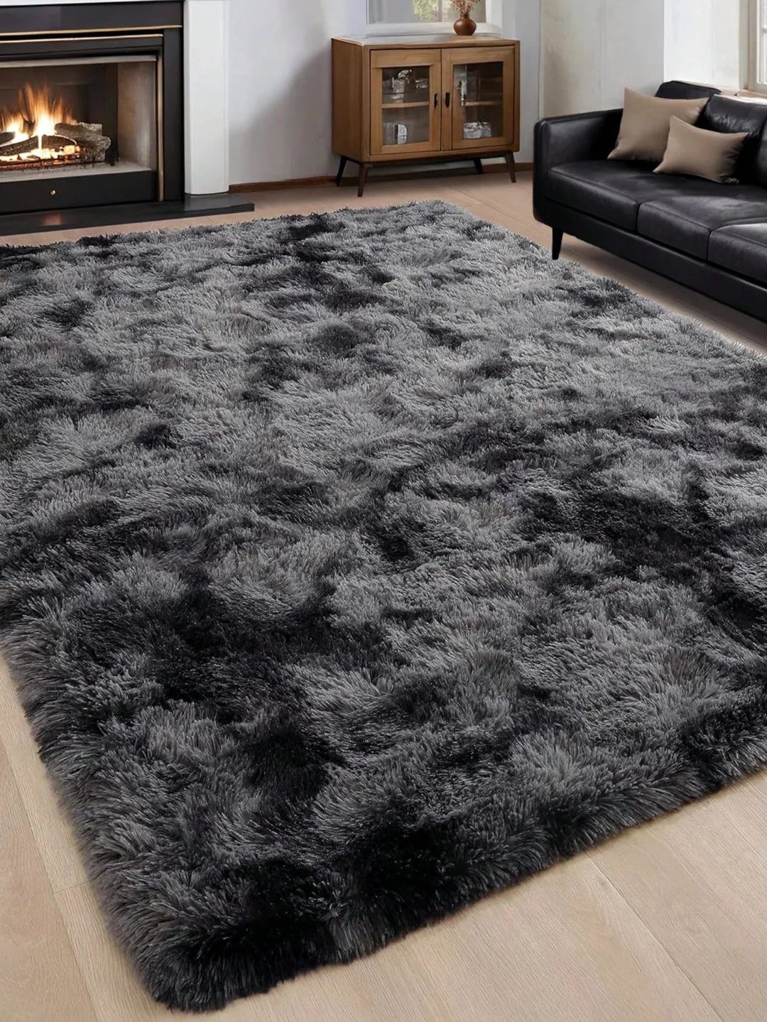 Grey and black shag rug on a light wood floor in a living room.