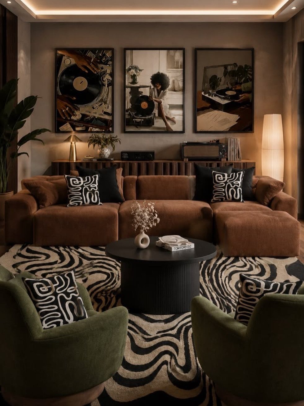 Dark brown sectional sofa and green armchairs on a black and white patterned rug.