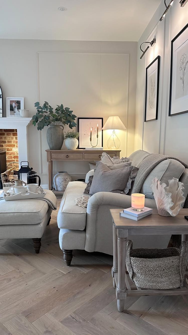 Farmhouse living room with neutral sofa, wooden furniture, woven basket, and greenery accents.
