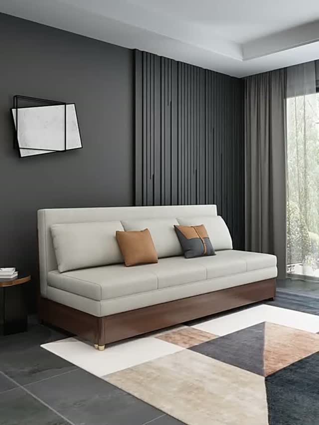 Beige tight-back sofa with wooden base on a geometric rug in modern room