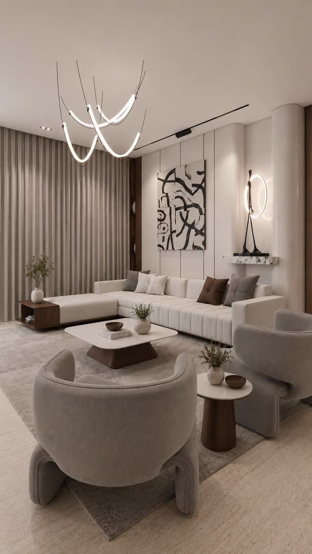 Modern minimalist living room with white sofa, gray armchairs, and abstract wall art.
