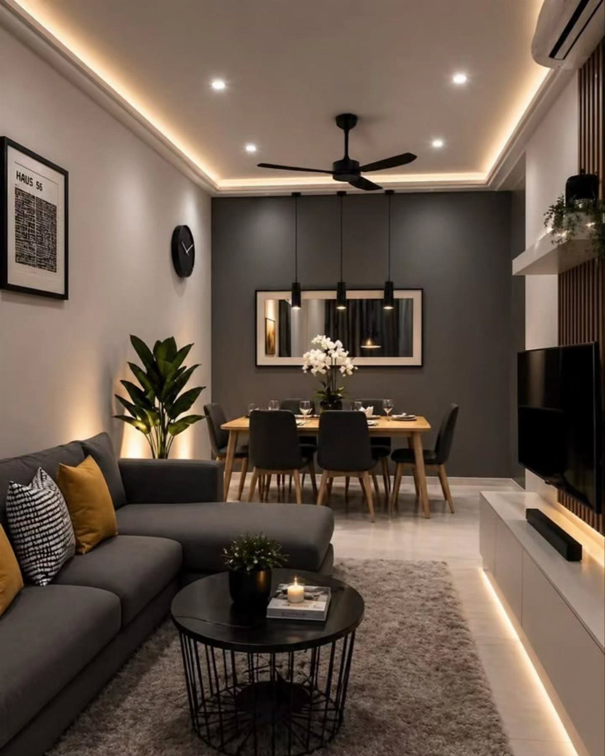 Gray living room with a dark sectional sofa and mustard yellow accent cushions.
