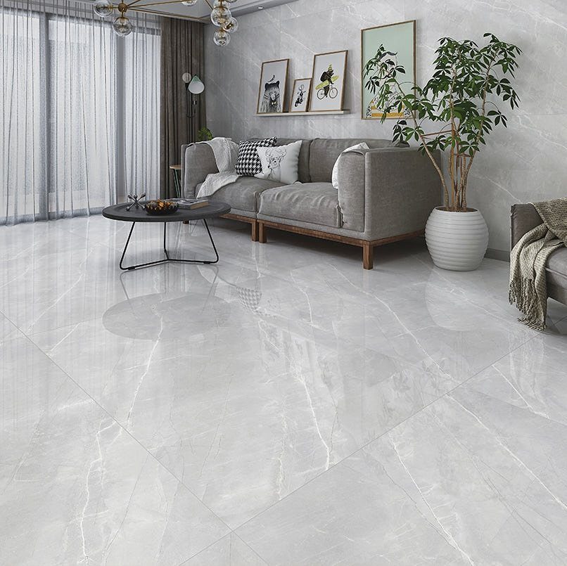 Polished gray marble tiled floor in a modern living room with gray furniture.