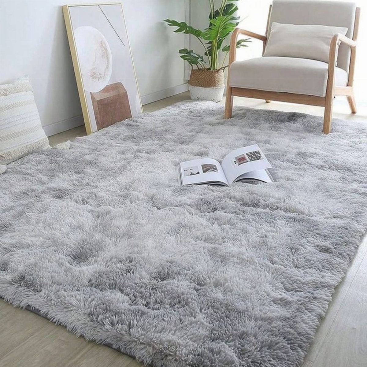 Light gray shag rug on a wooden floor in a bright living room