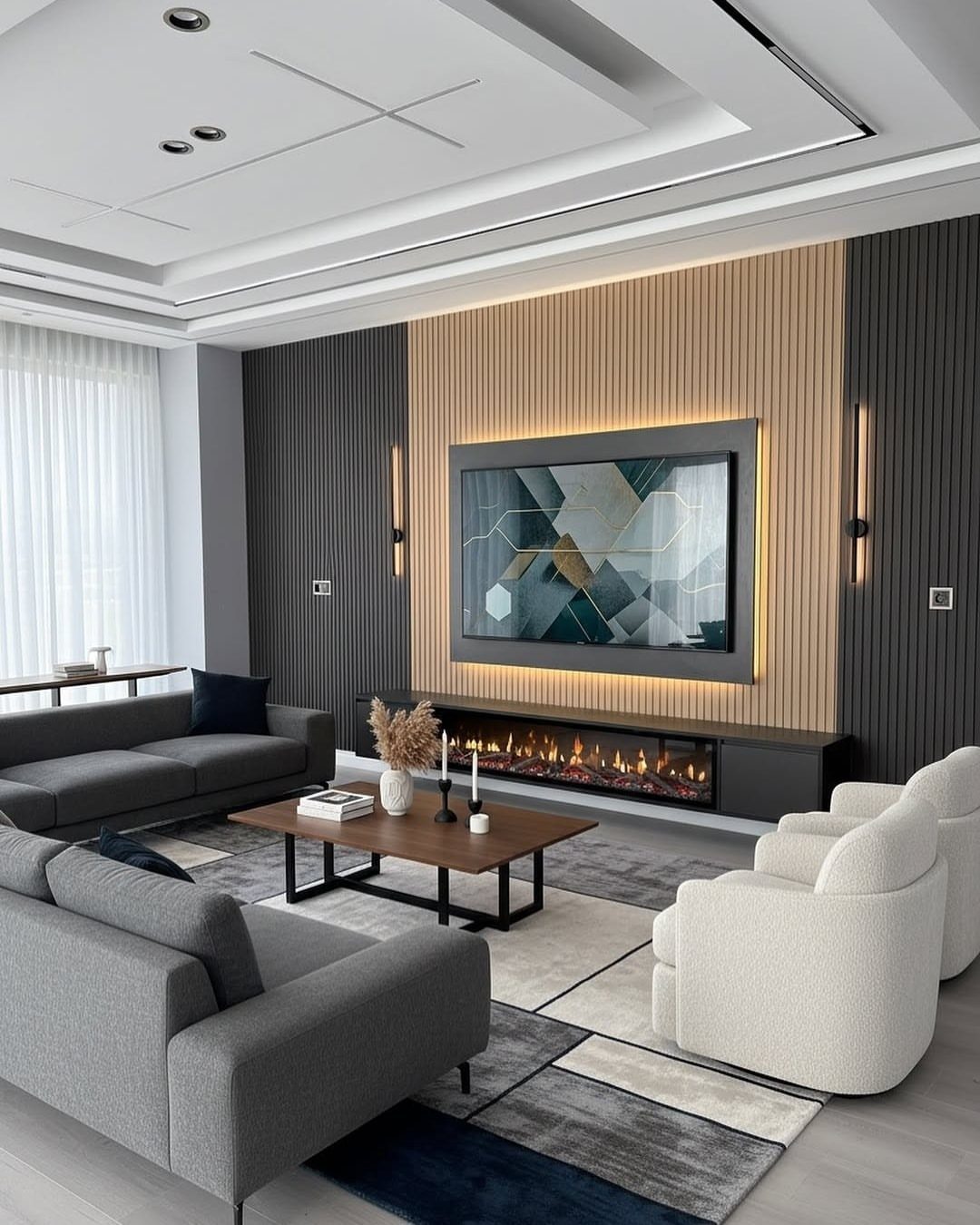Modern living room with gray sofas, white chairs, and light wood wall paneling.