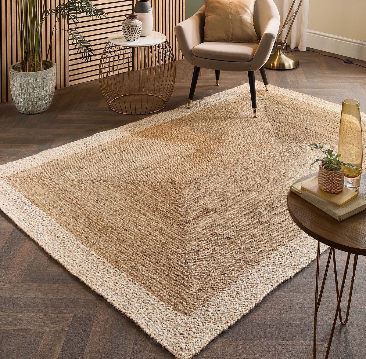 Beige low-pile neutral rug on dark wood floors in a modern living room