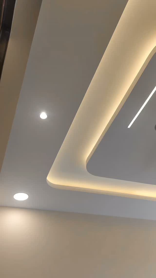 Modern white tray ceiling with warm integrated LED strip lighting and recessed spotlights