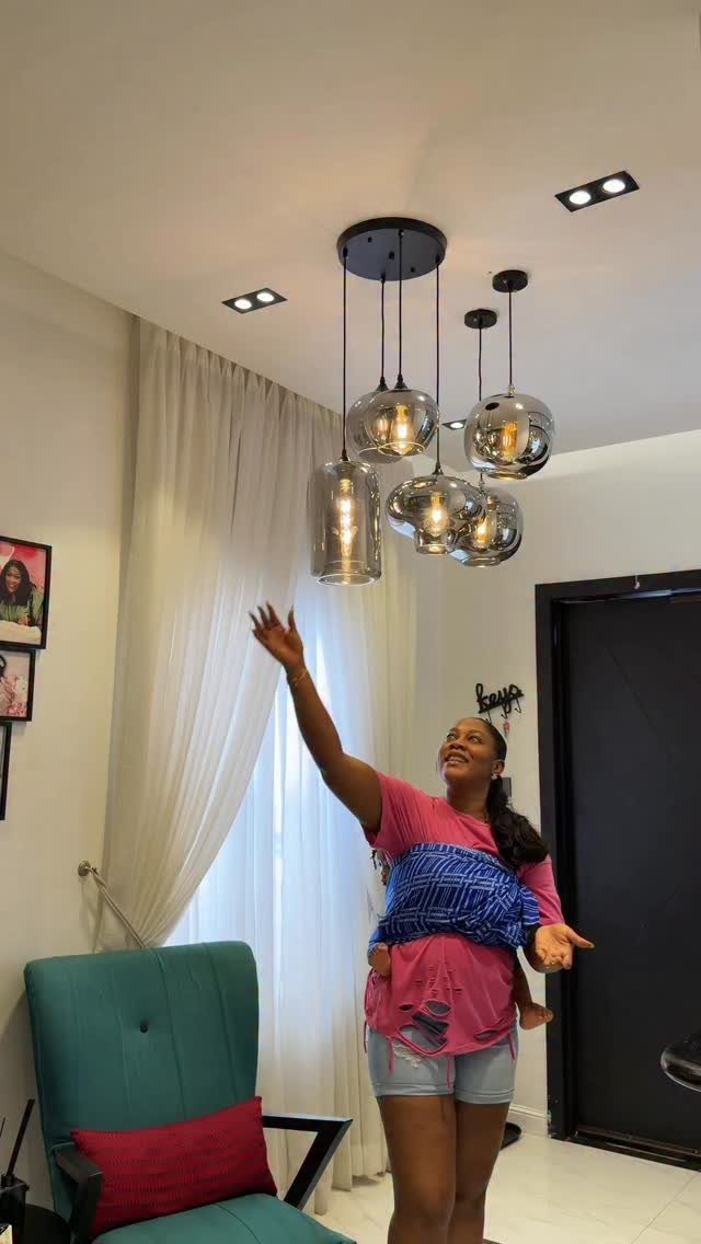 Modern glass globe pendant lights hanging from a white living room ceiling.