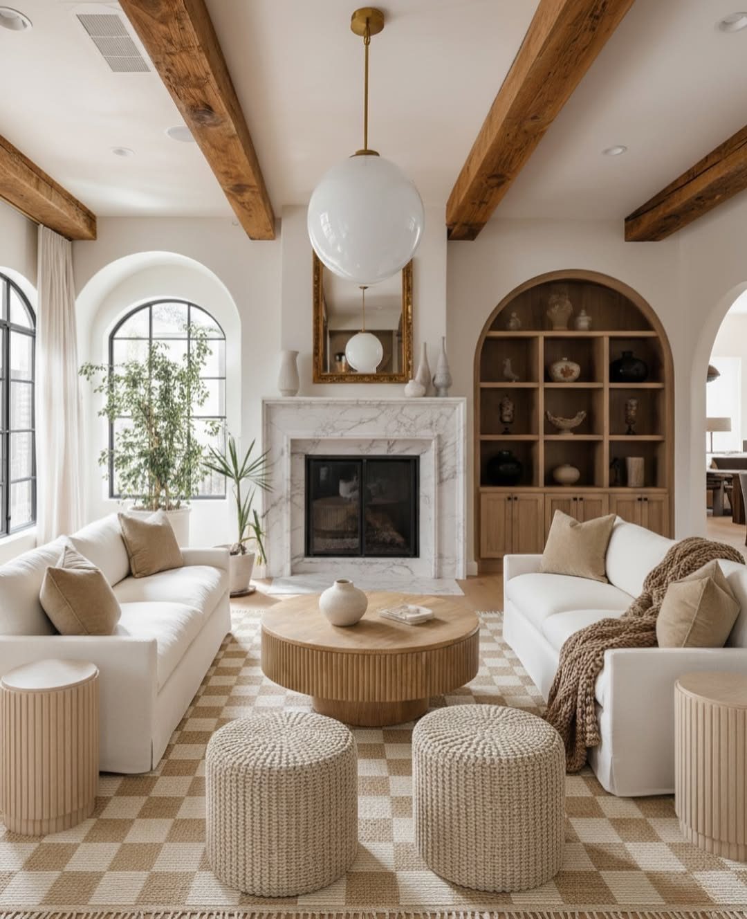 Rustic brown wooden beams on a white living room ceiling with globe lighting.