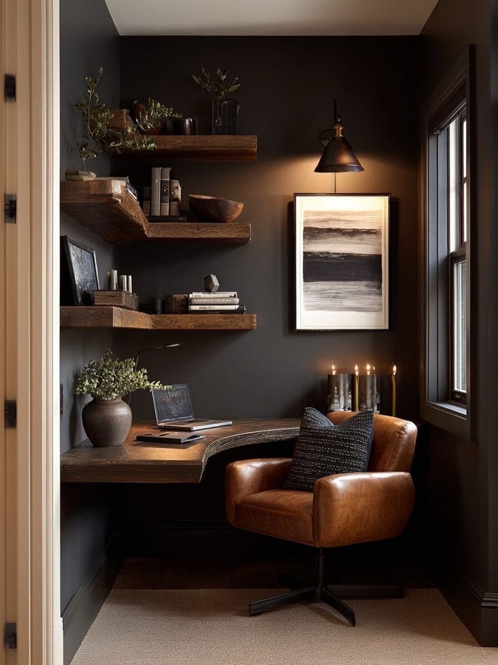 Curved wooden floating desk and leather chair in a dark moody office corner.