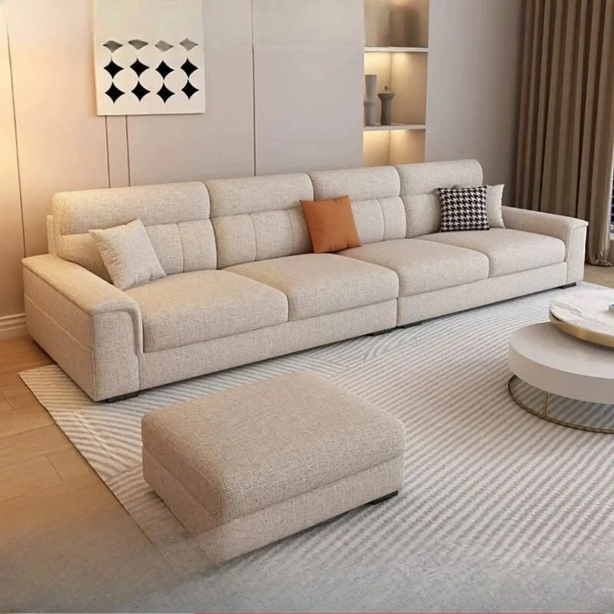 Beige fabric sofa with cushions and matching ottoman in a modern living room.