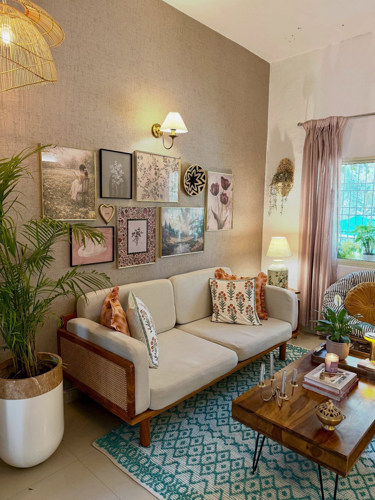 Light-colored cane sofa and wooden coffee table on a blue patterned area rug.