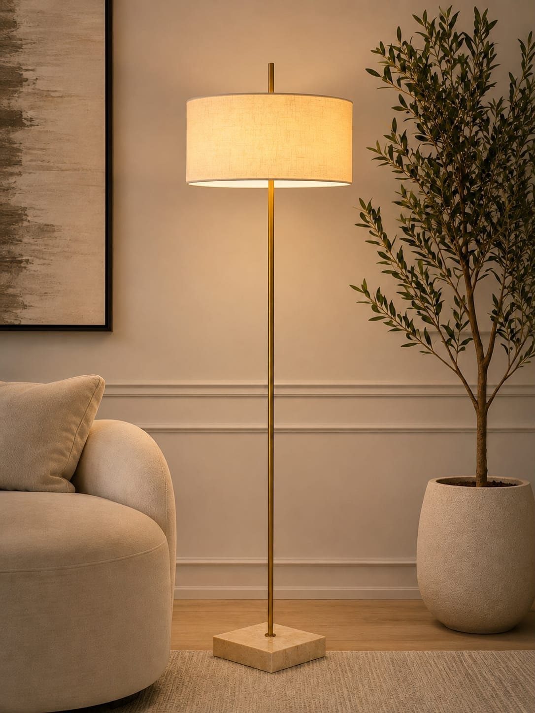 Gold floor lamp with cream shade in a modern living room setting.