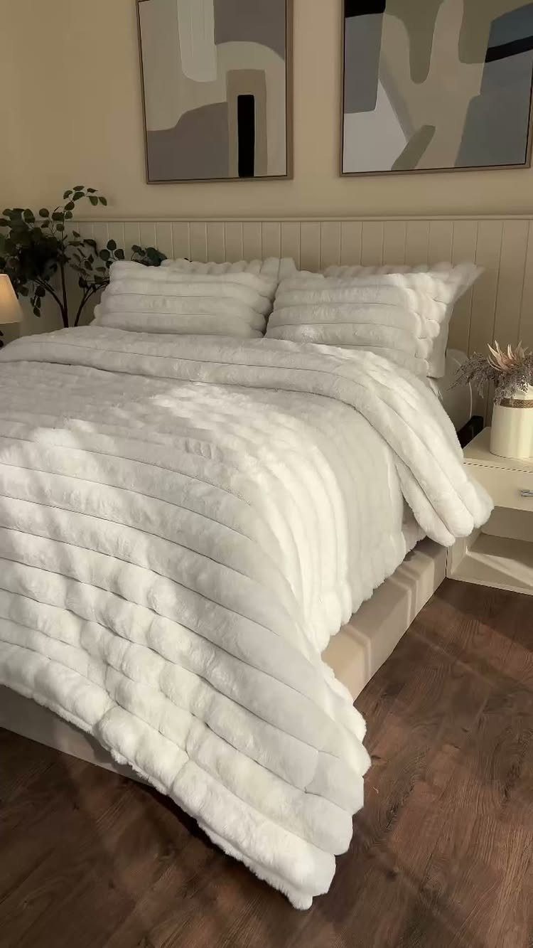 White ribbed faux-fur bedding on a bed in a modern bedroom setting