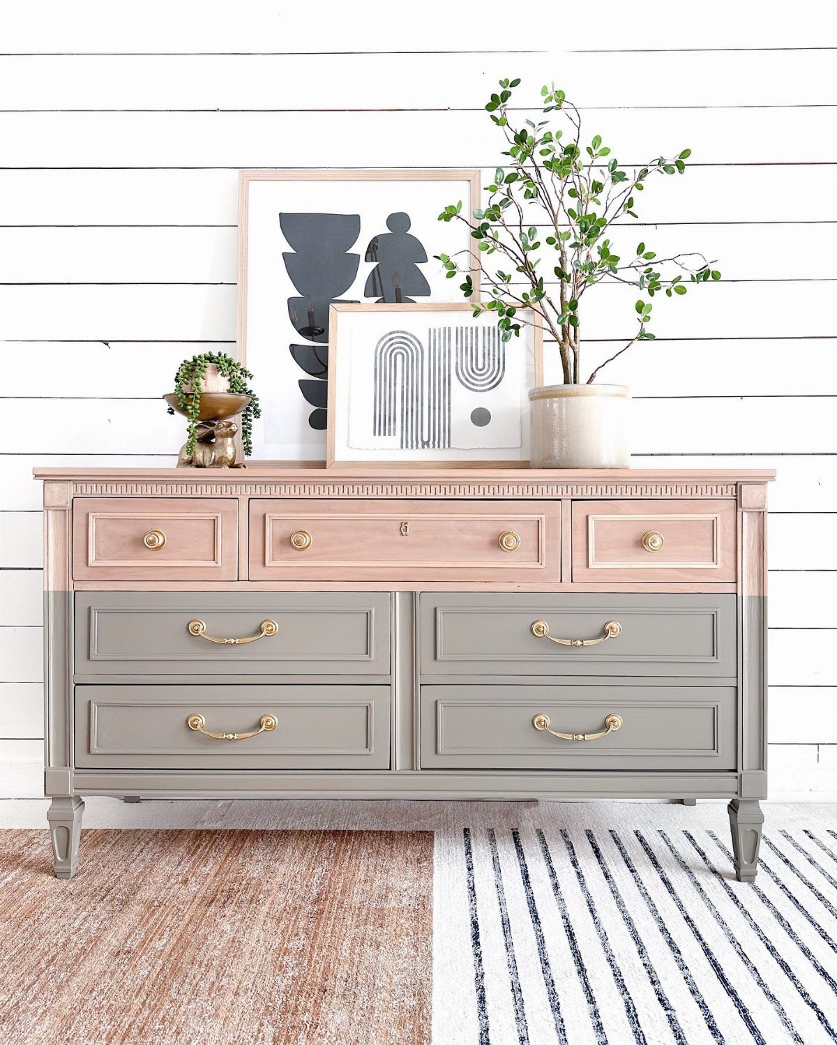 Two-tone peach and grey painted dresser with gold handles against white shiplap wall
