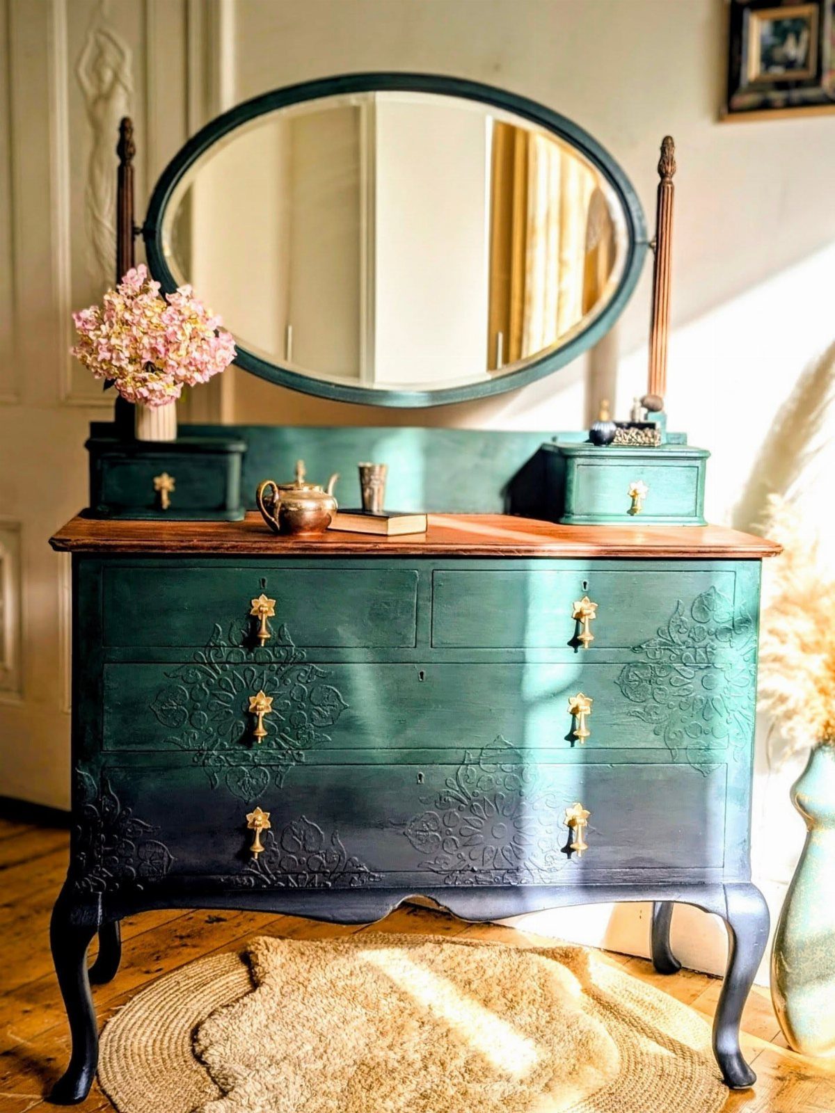 Teal painted vintage dresser with a natural wood top and oval mirror.