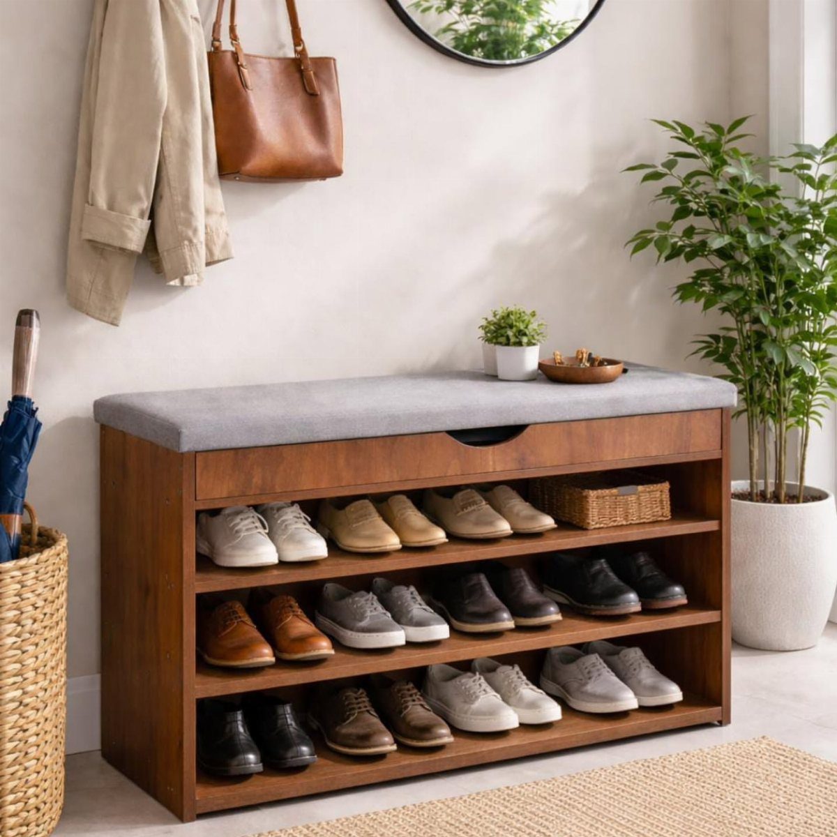 Wooden entryway shoe storage bench with grey cushion and multiple pairs of shoes.