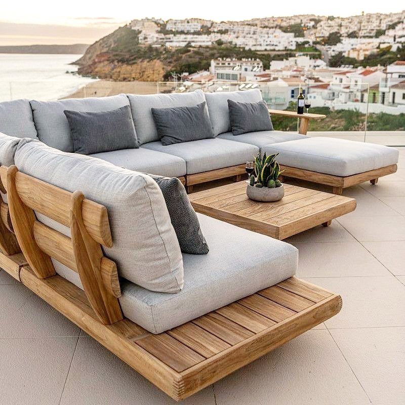 Modern teak wood outdoor sectional sofa and coffee table on a coastal patio